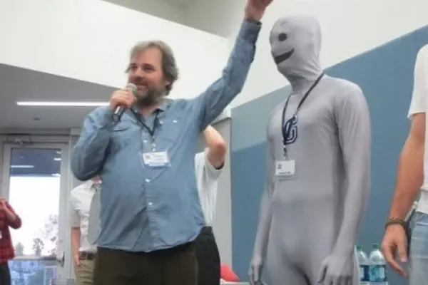 Dan Harmon beside a fan dressed as the Greendale Human Being