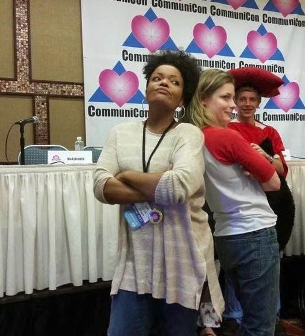 Fans posing together in front of a CommuniCon backdrop